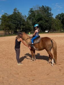 instructor adjusting student's foot