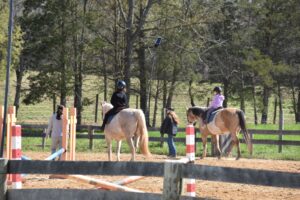 children on horseback with instructor